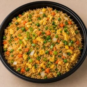 Wok-fried rice with egg, fresh vegetables and spring onion