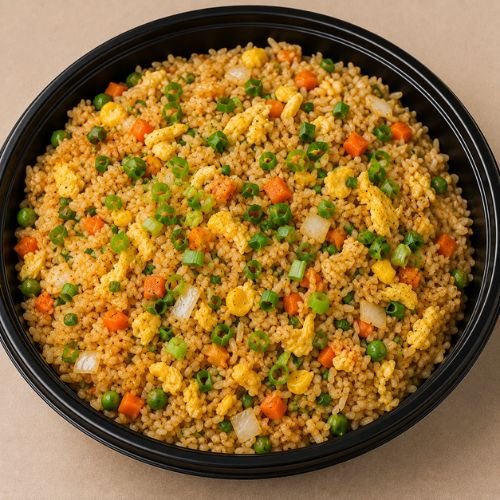Wok-fried rice with egg, fresh vegetables and spring onion